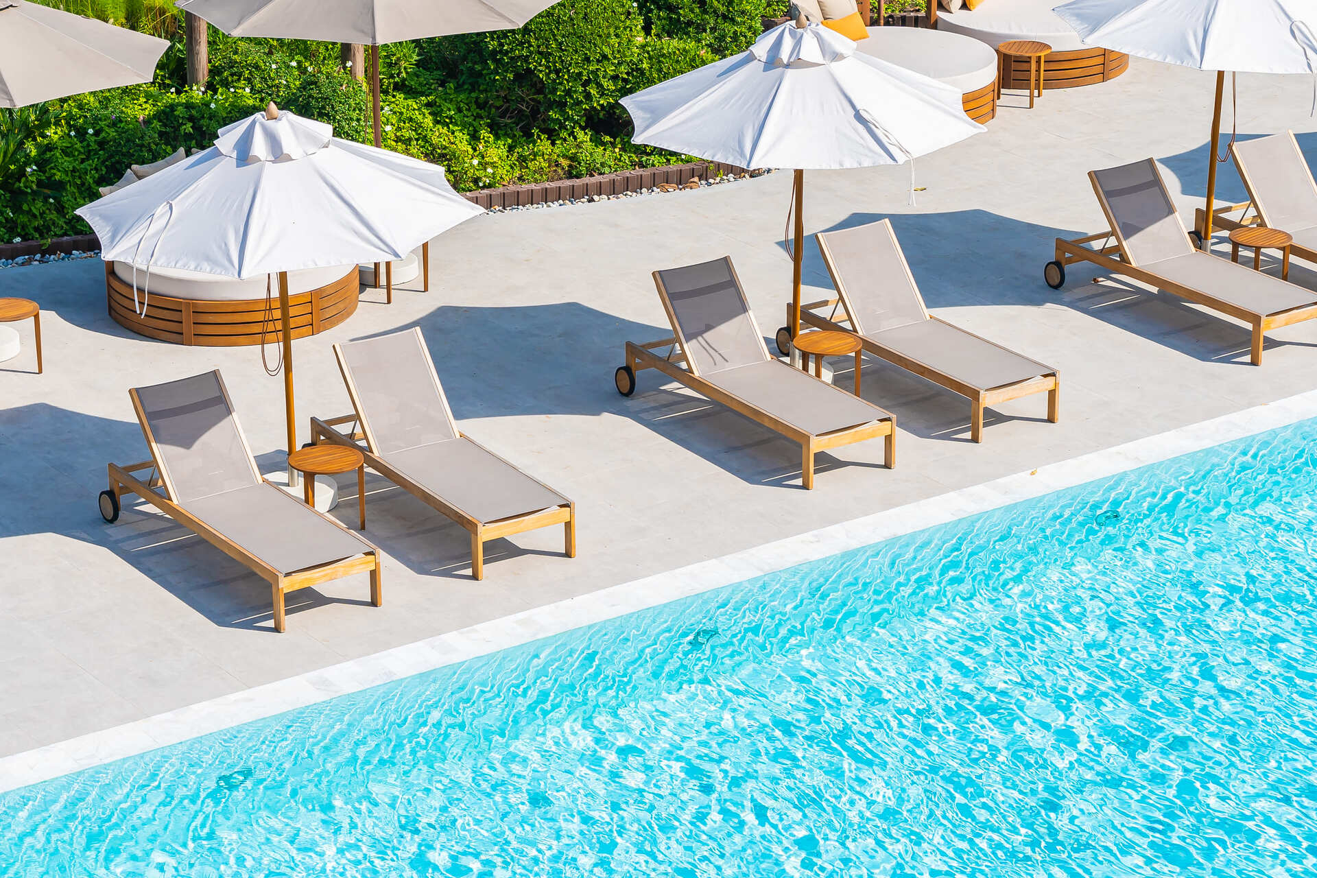 umbrella-deck-chair-around-outdoor-swimming-pool-hotel-resort-nearly-sea-beach-ocean