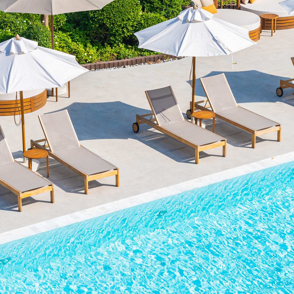 umbrella-deck-chair-around-outdoor-swimming-pool-hotel-resort-nearly-sea-beach-ocean